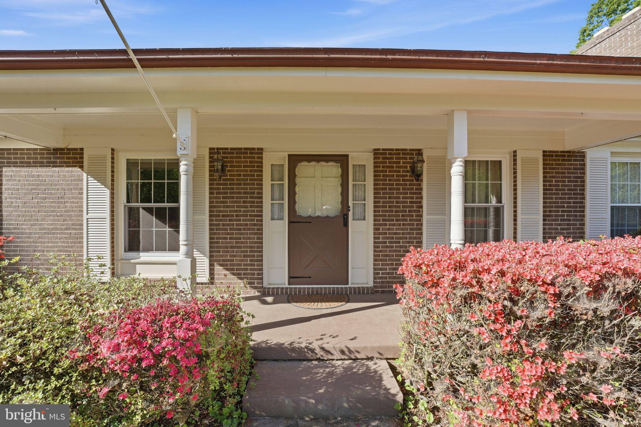 4201 Goldmine Road Goldvein, VA 22720 - Photo 9 of 10 Charming entrance with vibrant blooms.