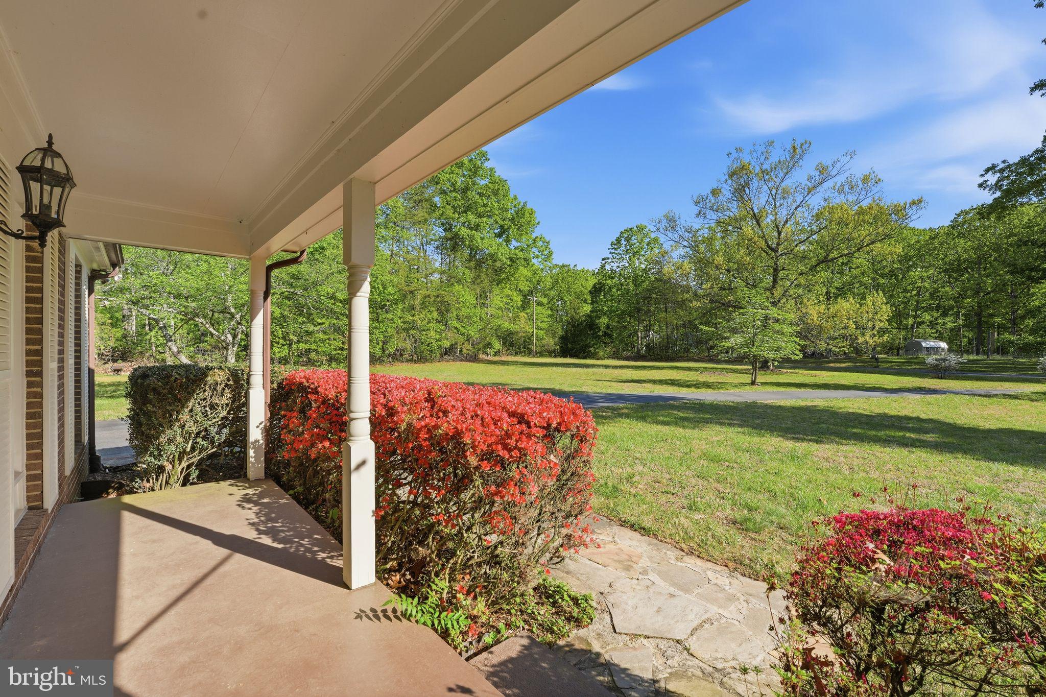 4201 Goldmine Road Goldvein, VA 22720 - Photo 10 of 10 Charming porch with lush greenery view.