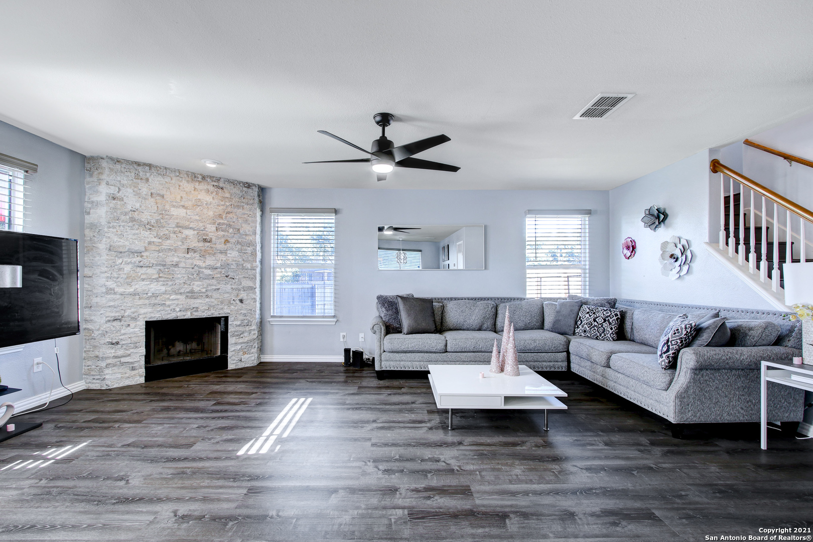 a living room with furniture a fireplace and a large window