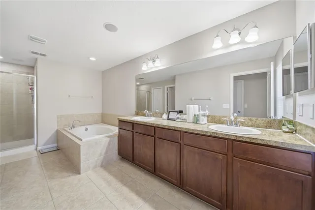 a spacious bathroom with a double vanity sink mirror double and bathtub