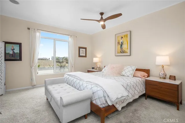 a bedroom with a bed a couch and a window