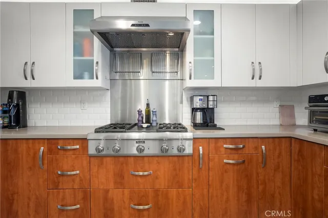a kitchen with stainless steel appliances granite countertop a sink and cabinets