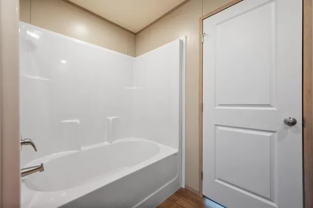 a white bath tub sitting next to a white sink