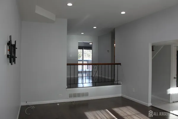 a view of wooden floor and windows in a room