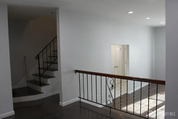 a view of a hallway with wooden floor and entryway