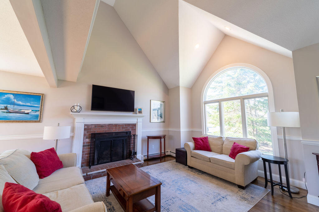 18 Windsor Road Sandwich, MA 02563 - Photo 14 of 35 a living room with furniture a flat screen tv and a fireplace