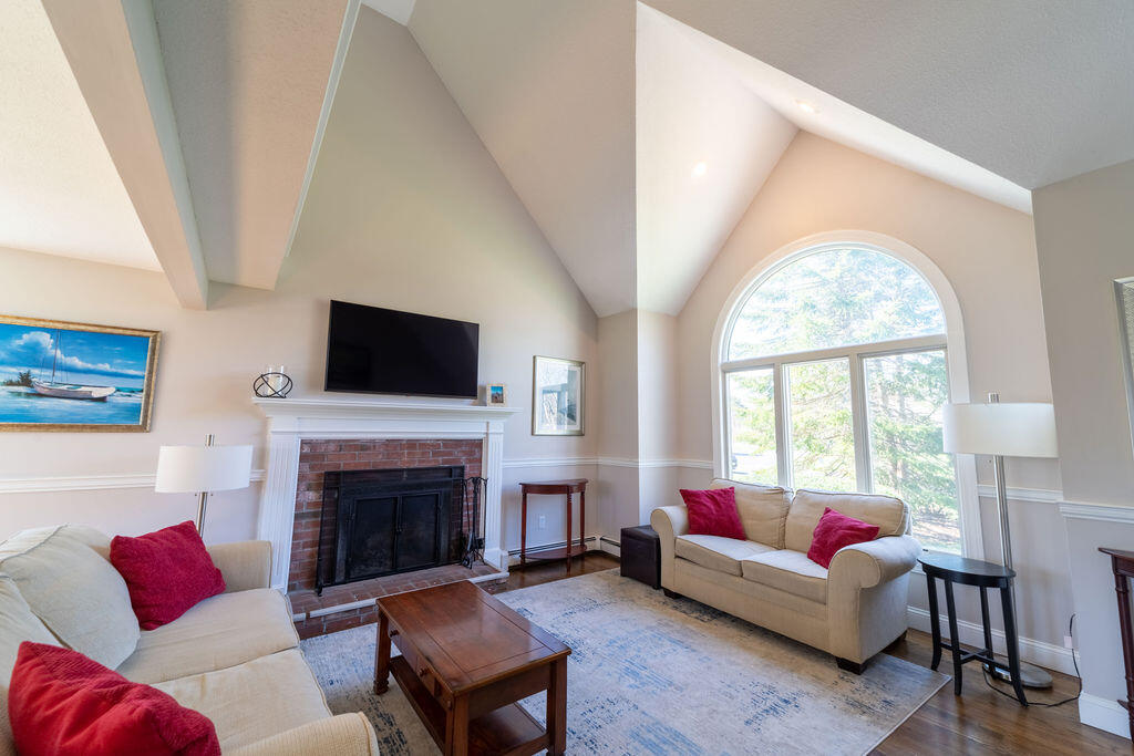 18 Windsor Road Sandwich, MA 02563 - Photo 15 of 35 a living room with furniture a flat screen tv and a fireplace