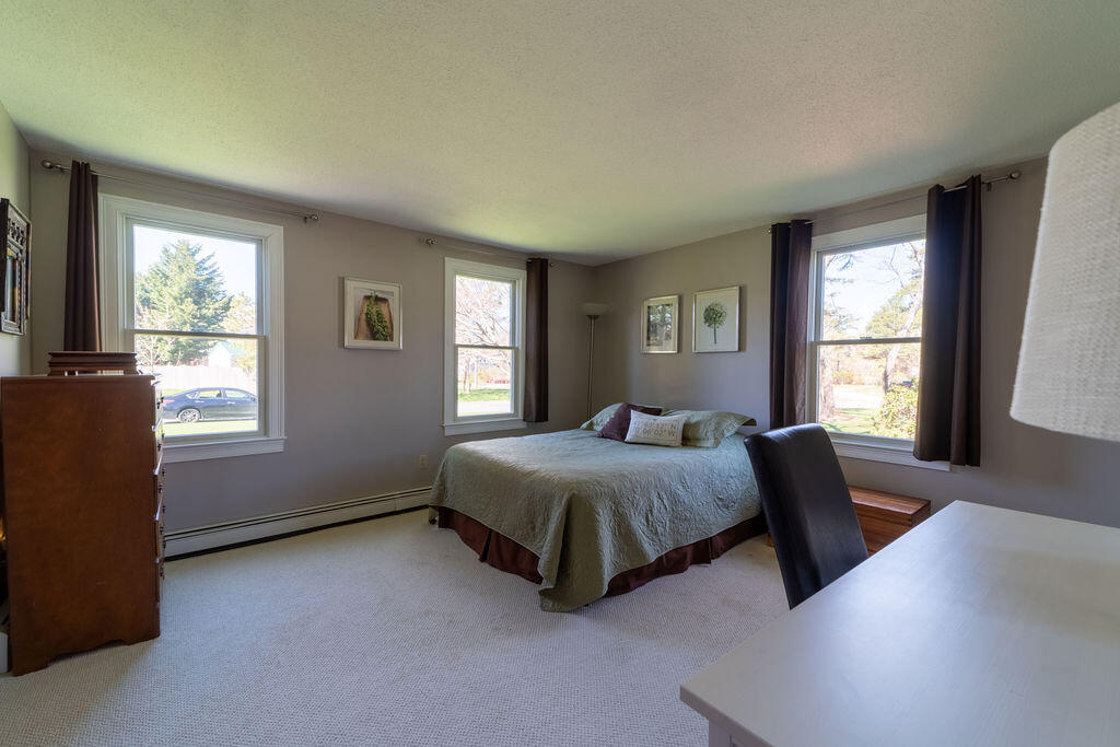 18 Windsor Road Sandwich, MA 02563 - Photo 18 of 35 a bedroom with a bed and a window