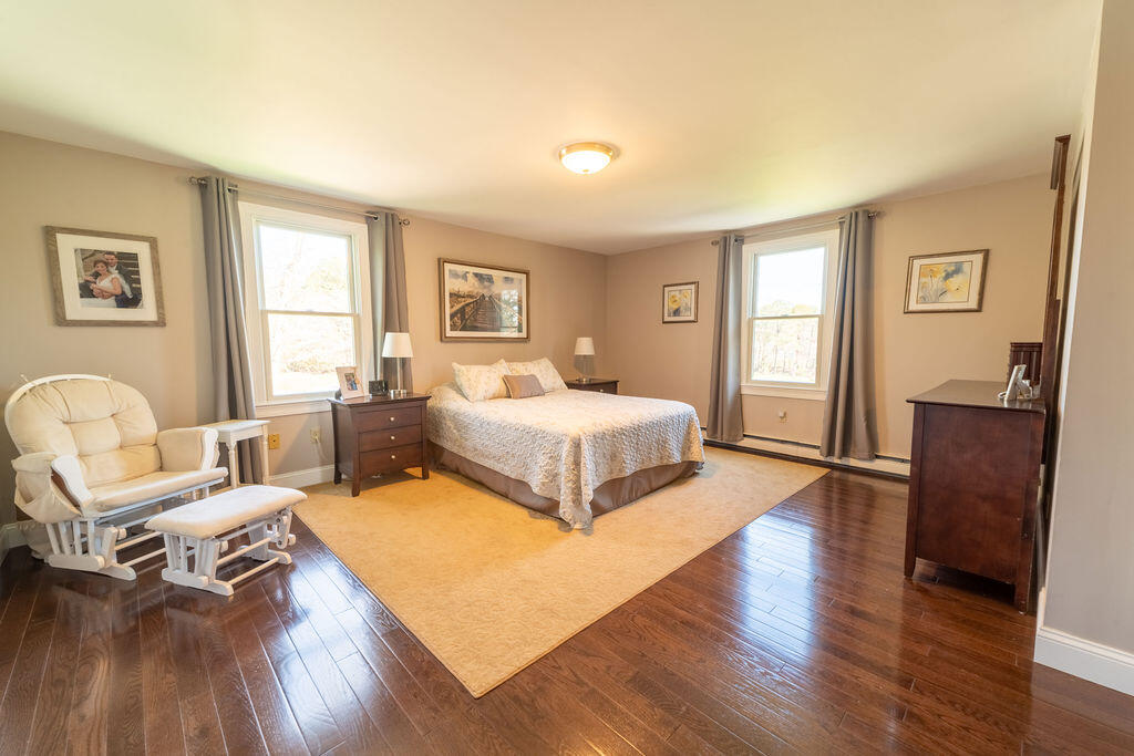 18 Windsor Road Sandwich, MA 02563 - Photo 20 of 35 a bedroom with a bed and wooden floor