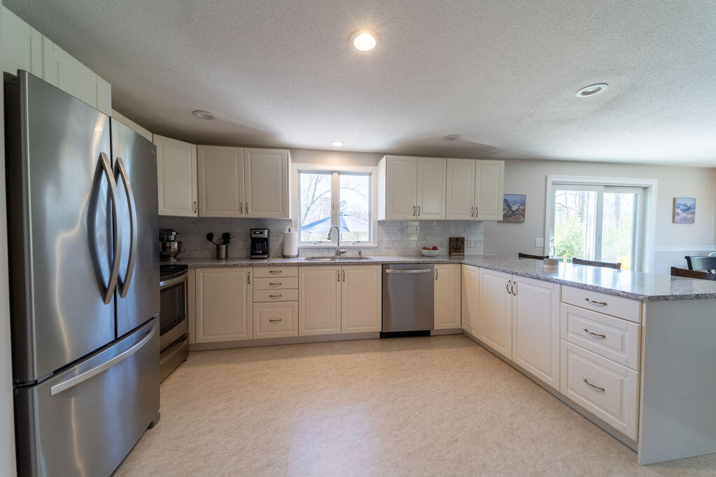 18 Windsor Road Sandwich, MA 02563 - Photo 2 of 35 a kitchen with granite countertop white cabinets and stainless steel appliances