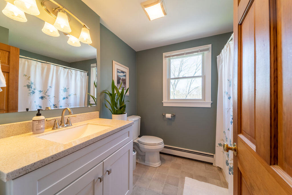 18 Windsor Road Sandwich, MA 02563 - Photo 24 of 35 a bath room with a sink a toilet and a mirror