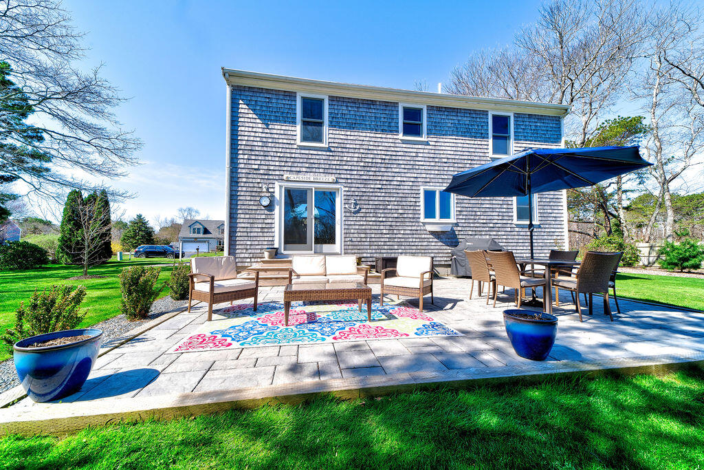 18 Windsor Road Sandwich, MA 02563 - Photo 26 of 35 a view of a house with backyard sitting area and garden