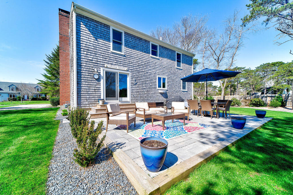 18 Windsor Road Sandwich, MA 02563 - Photo 27 of 35 a view of a house with backyard sitting area and garden