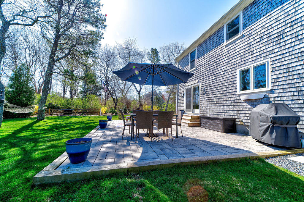 18 Windsor Road Sandwich, MA 02563 - Photo 28 of 35 a view of a deck with table and chairs under an umbrella