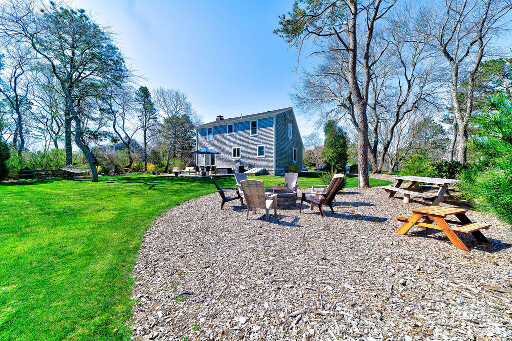 18 Windsor Road Sandwich, MA 02563 - Photo 30 of 35 a row of palm trees sitting in a yard with swimming pool