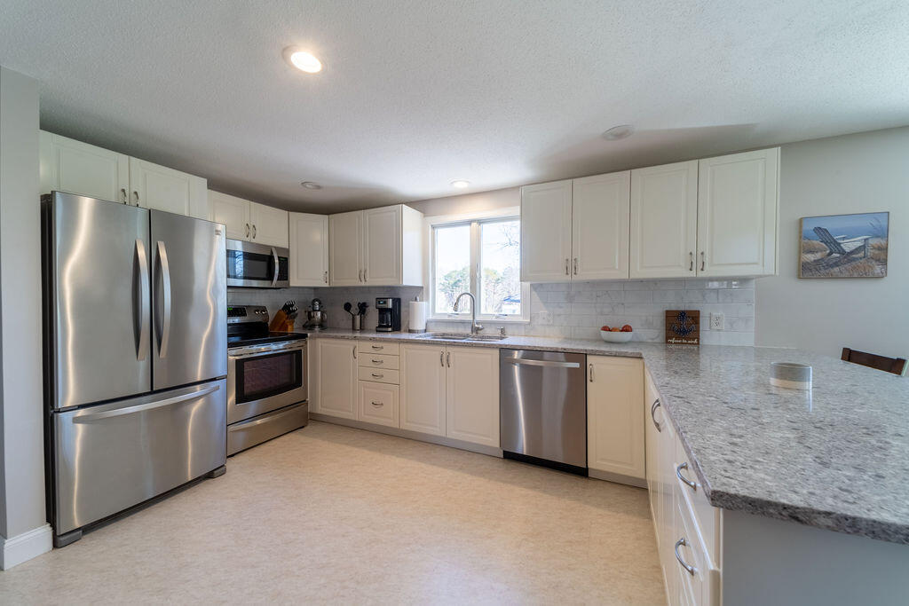 18 Windsor Road Sandwich, MA 02563 - Photo 7 of 35 a kitchen with stainless steel appliances granite countertop a refrigerator sink and stove