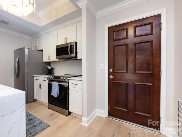 a kitchen with a refrigerator stove and microwave