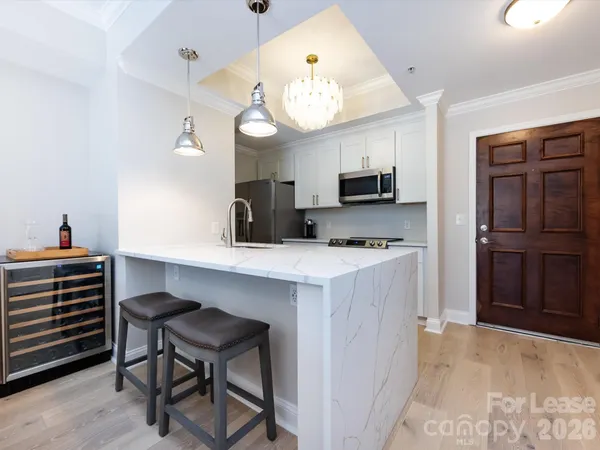 a kitchen with cabinets a window and stainless steel appliances