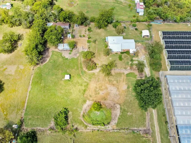 an aerial view of residential house with pool and yard