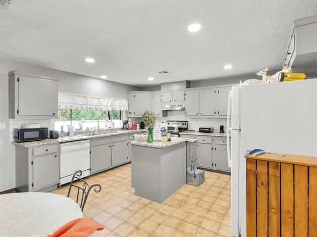 a kitchen with sink cabinets and window
