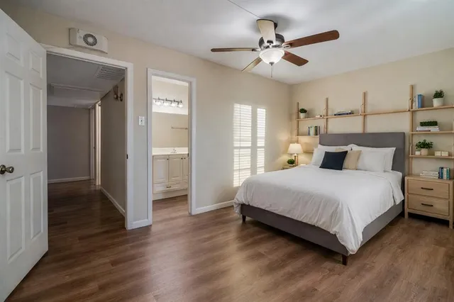 a bedroom with a large bed and a ceiling fan