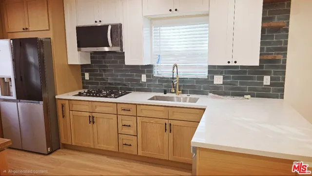 a kitchen with stainless steel appliances a sink stove and cabinets