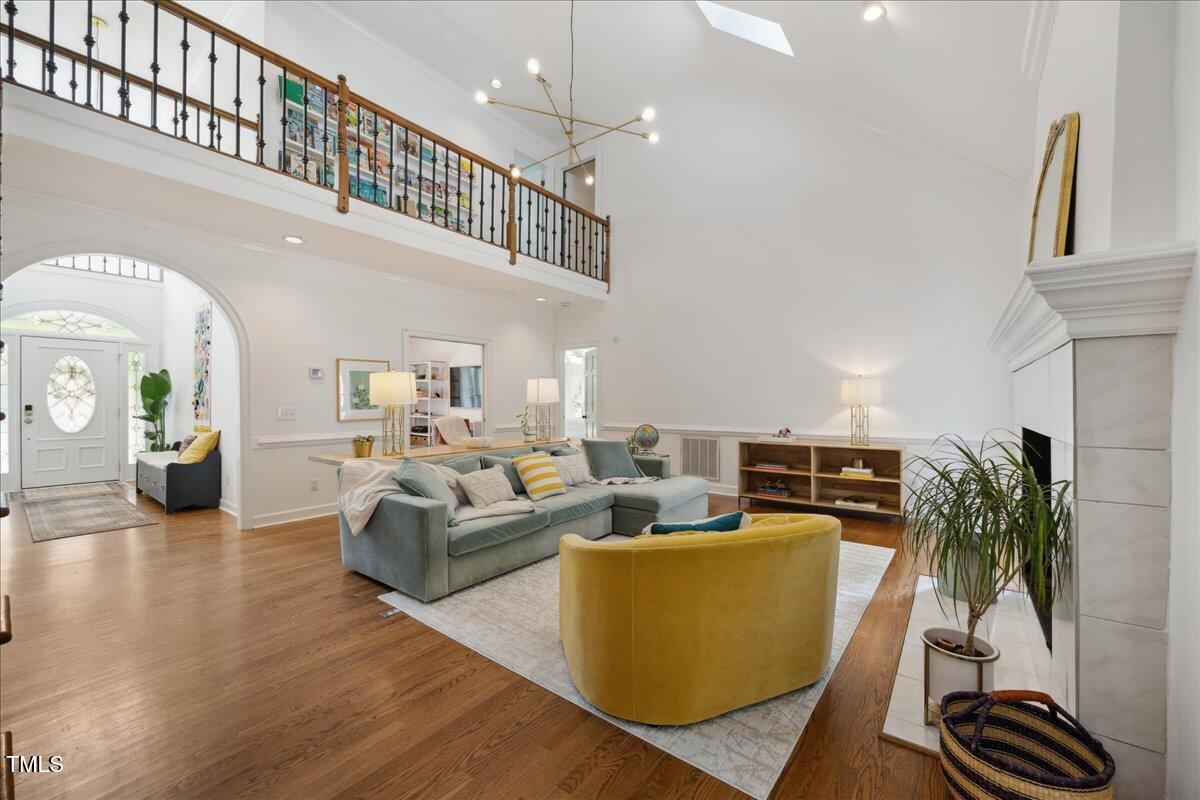 7917 Rooksley Court Raleigh, NC 27615 - Photo 12 of 45 a living room with furniture and a potted plant