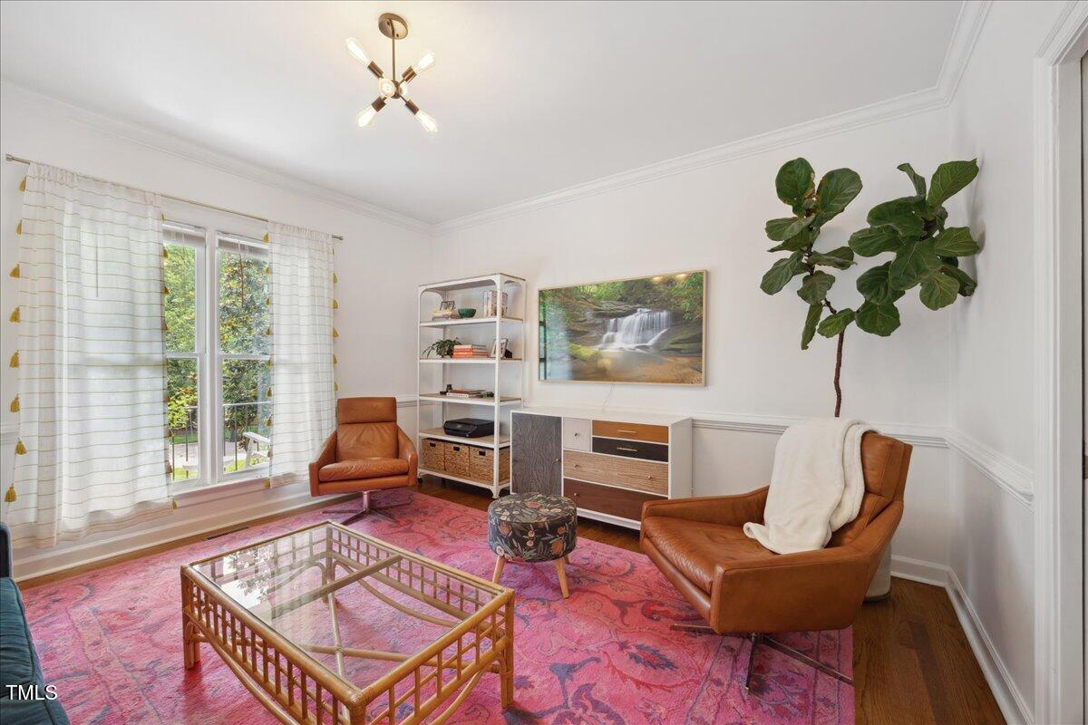 7917 Rooksley Court Raleigh, NC 27615 - Photo 14 of 45 a living room with furniture flowers and a window