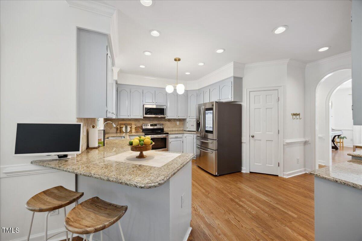 7917 Rooksley Court Raleigh, NC 27615 - Photo 16 of 45 a kitchen with refrigerator and microwave