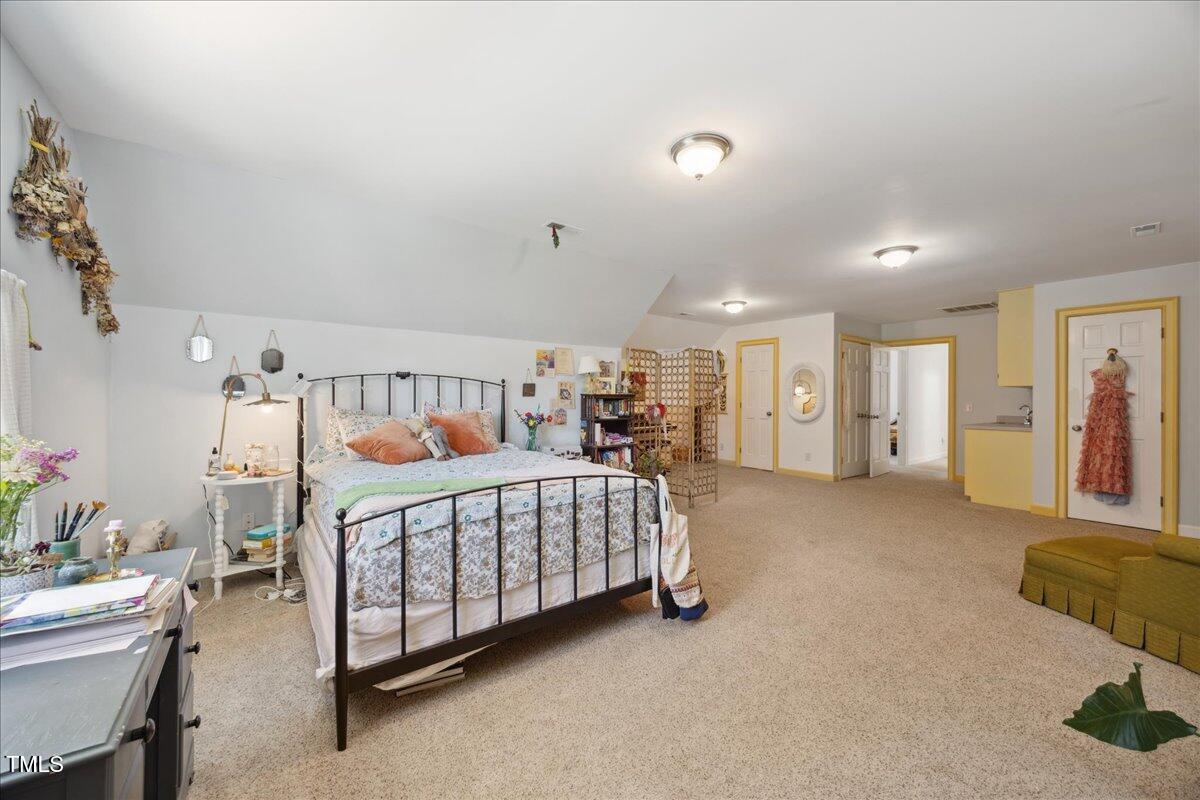 7917 Rooksley Court Raleigh, NC 27615 - Photo 32 of 45 a bedroom with furniture and a baby crib