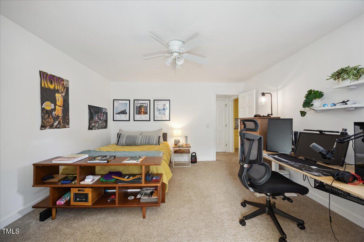 7917 Rooksley Court Raleigh, NC 27615 - Photo 34 of 45 a bedroom with a bed and a chandelier