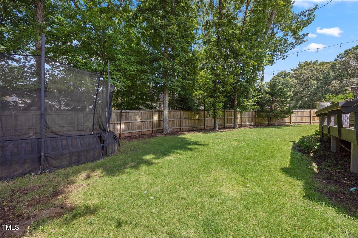 7917 Rooksley Court Raleigh, NC 27615 - Photo 40 of 45 a view of a yard with a large tree