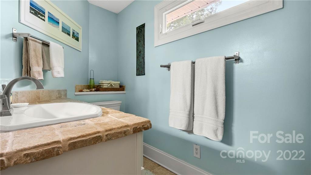 11147 Scullers Run Tega Cay, SC 29708 - Photo 30 of 39 a bathroom with a sink and a mirror