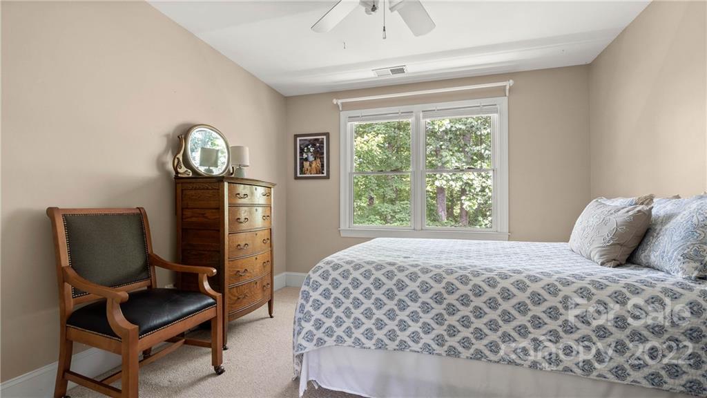 11147 Scullers Run Tega Cay, SC 29708 - Photo 32 of 39 a bedroom with a bed chair and window