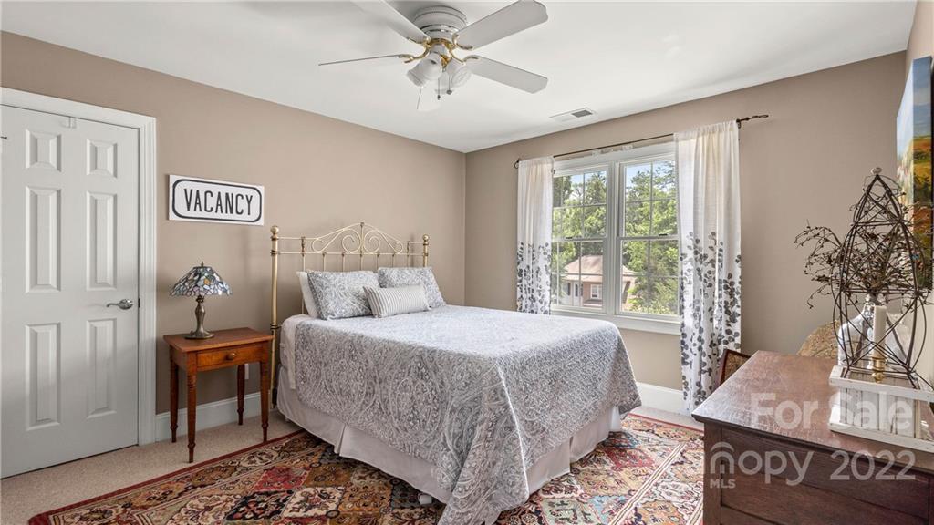 11147 Scullers Run Tega Cay, SC 29708 - Photo 34 of 39 a bedroom with a bed and a table with potted plant
