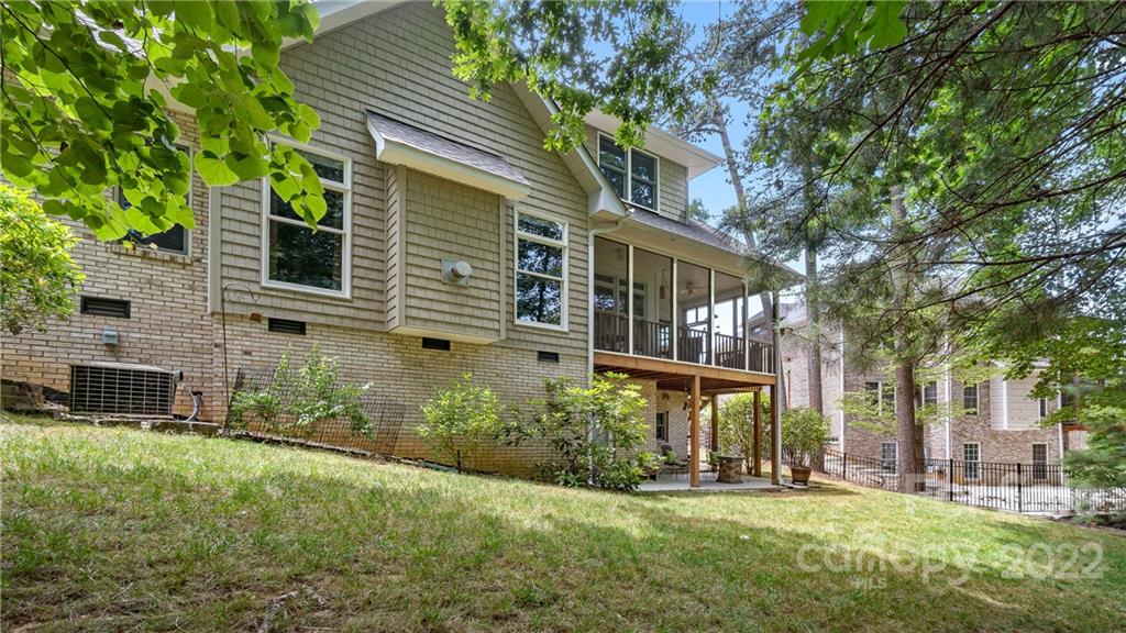 11147 Scullers Run Tega Cay, SC 29708 - Photo 38 of 39 a view of a brick house with a yard and plants