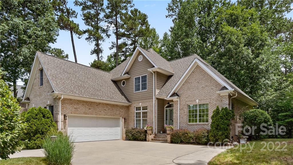 11147 Scullers Run Tega Cay, SC 29708 - Photo 5 of 39 a front view of a house with a yard garage and outdoor seating