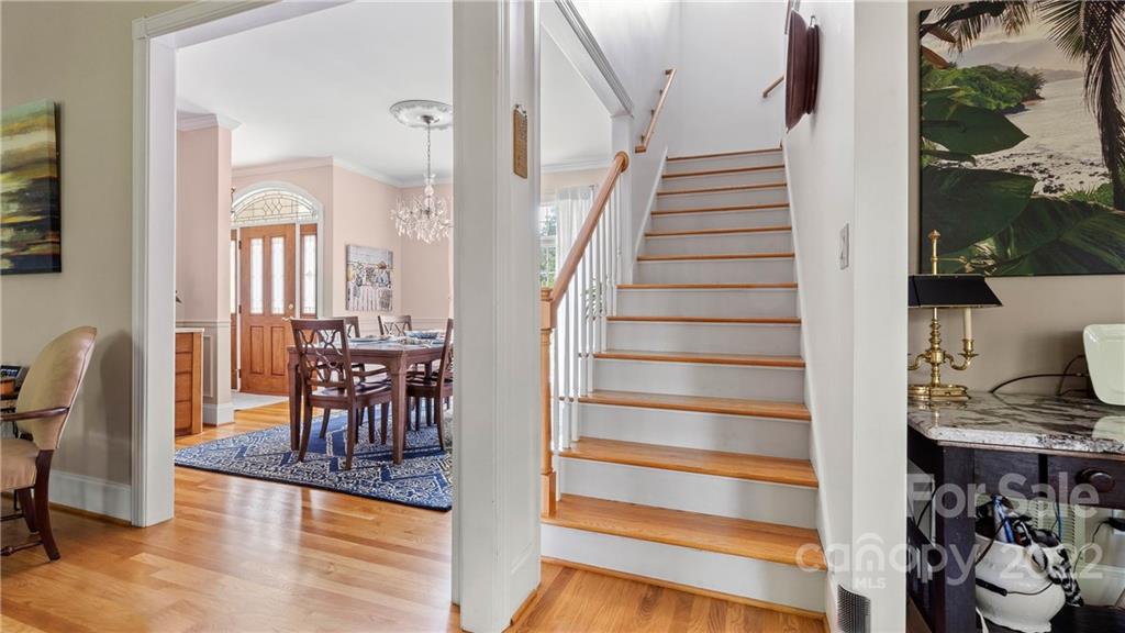 11147 Scullers Run Tega Cay, SC 29708 - Photo 9 of 39 a view of a hallway with wooden floor and dining room view