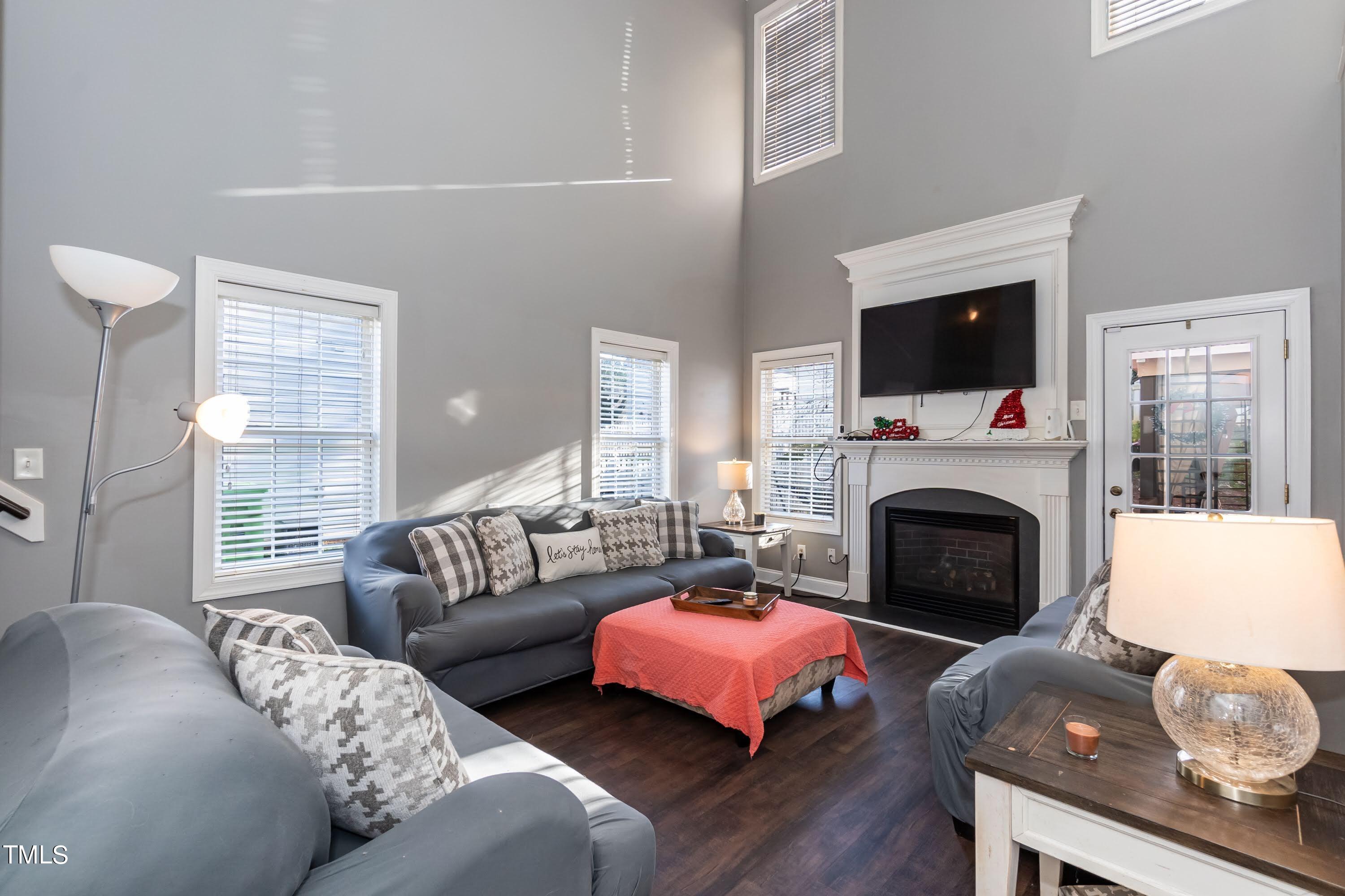 5001 Morning Edge Drive Raleigh, NC 27613 - Photo 11 of 25 a living room with furniture a flat screen tv and a fireplace