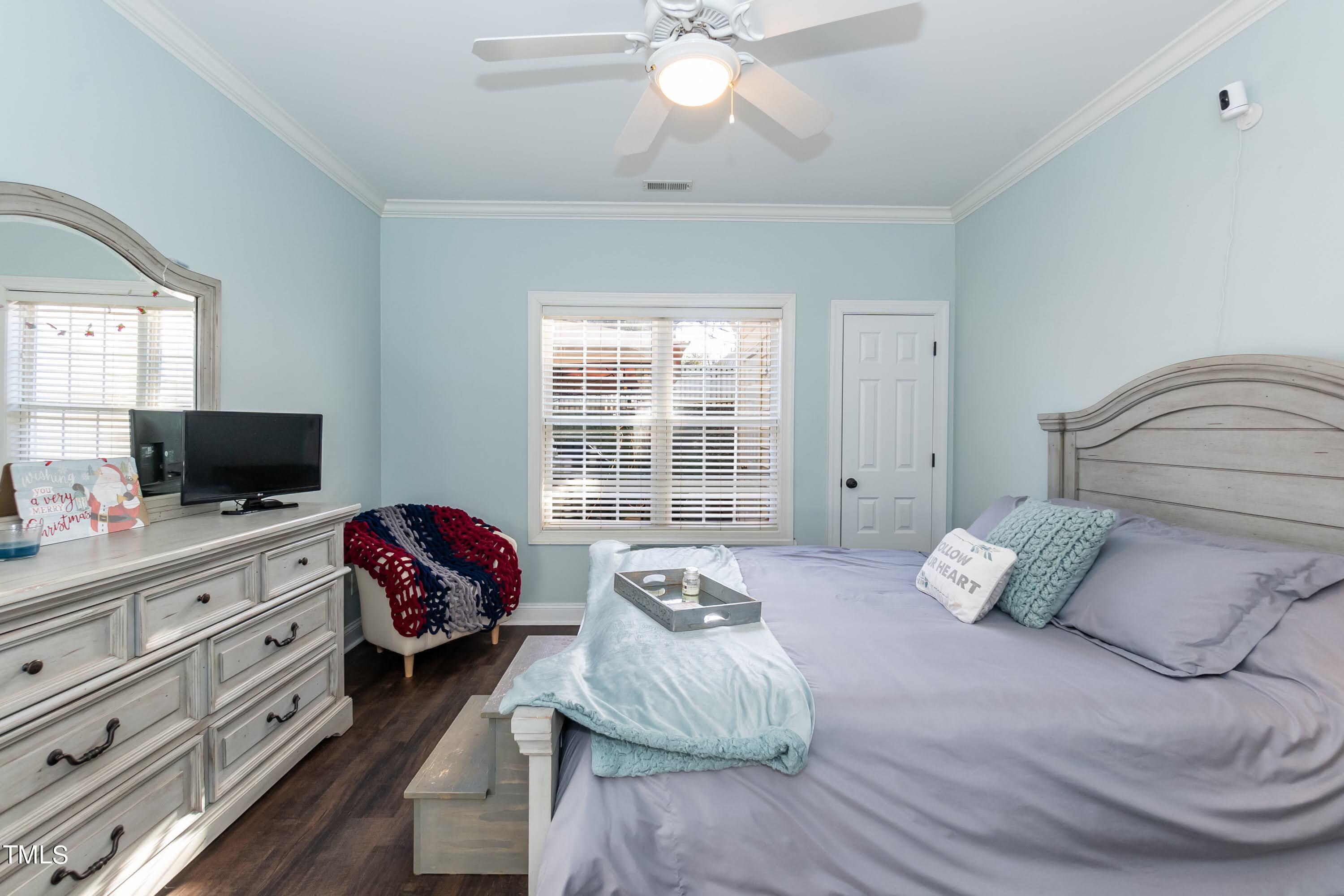 5001 Morning Edge Drive Raleigh, NC 27613 - Photo 17 of 25 a bedroom with a bed and a television