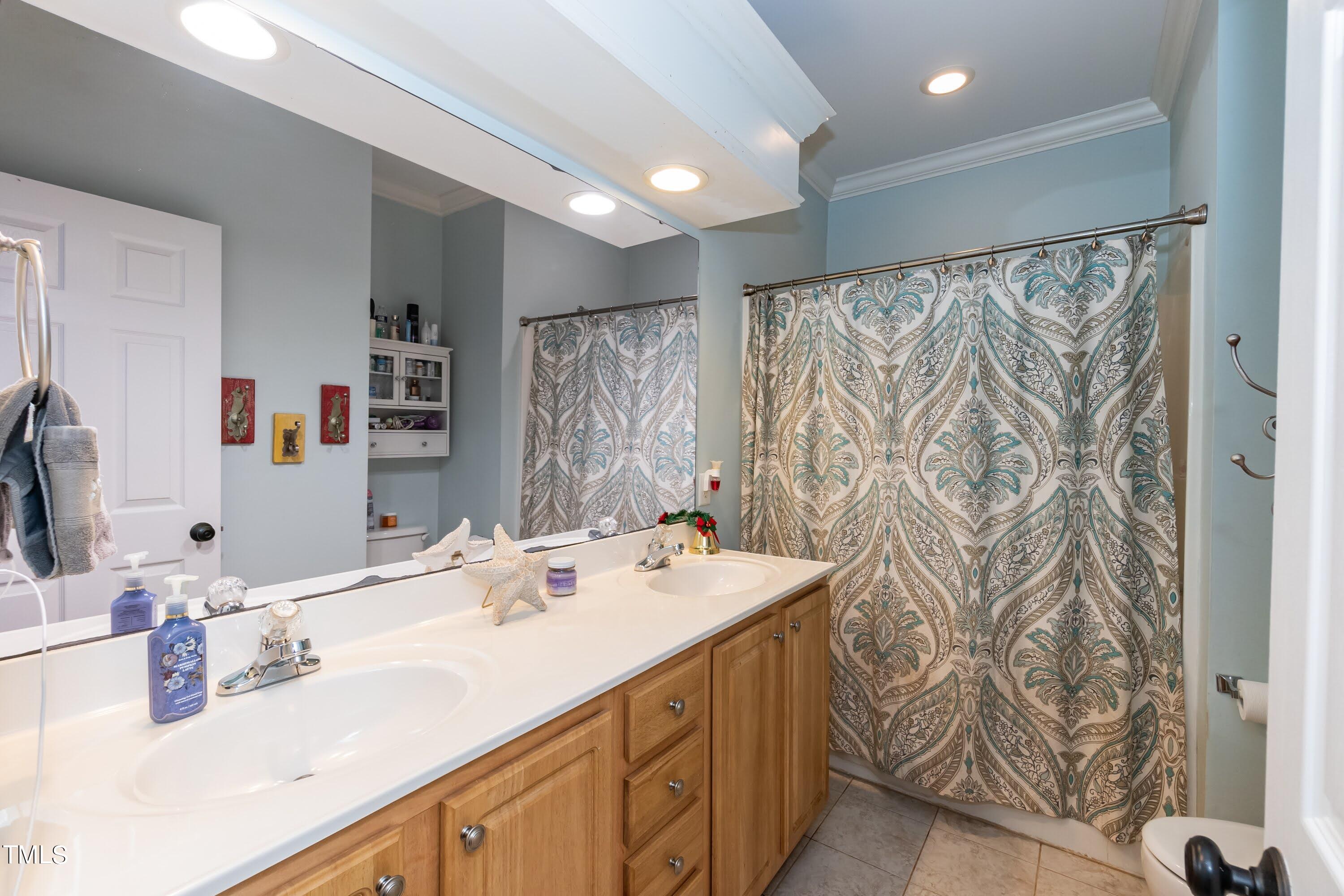 5001 Morning Edge Drive Raleigh, NC 27613 - Photo 18 of 25 a bathroom with a sink and a mirror