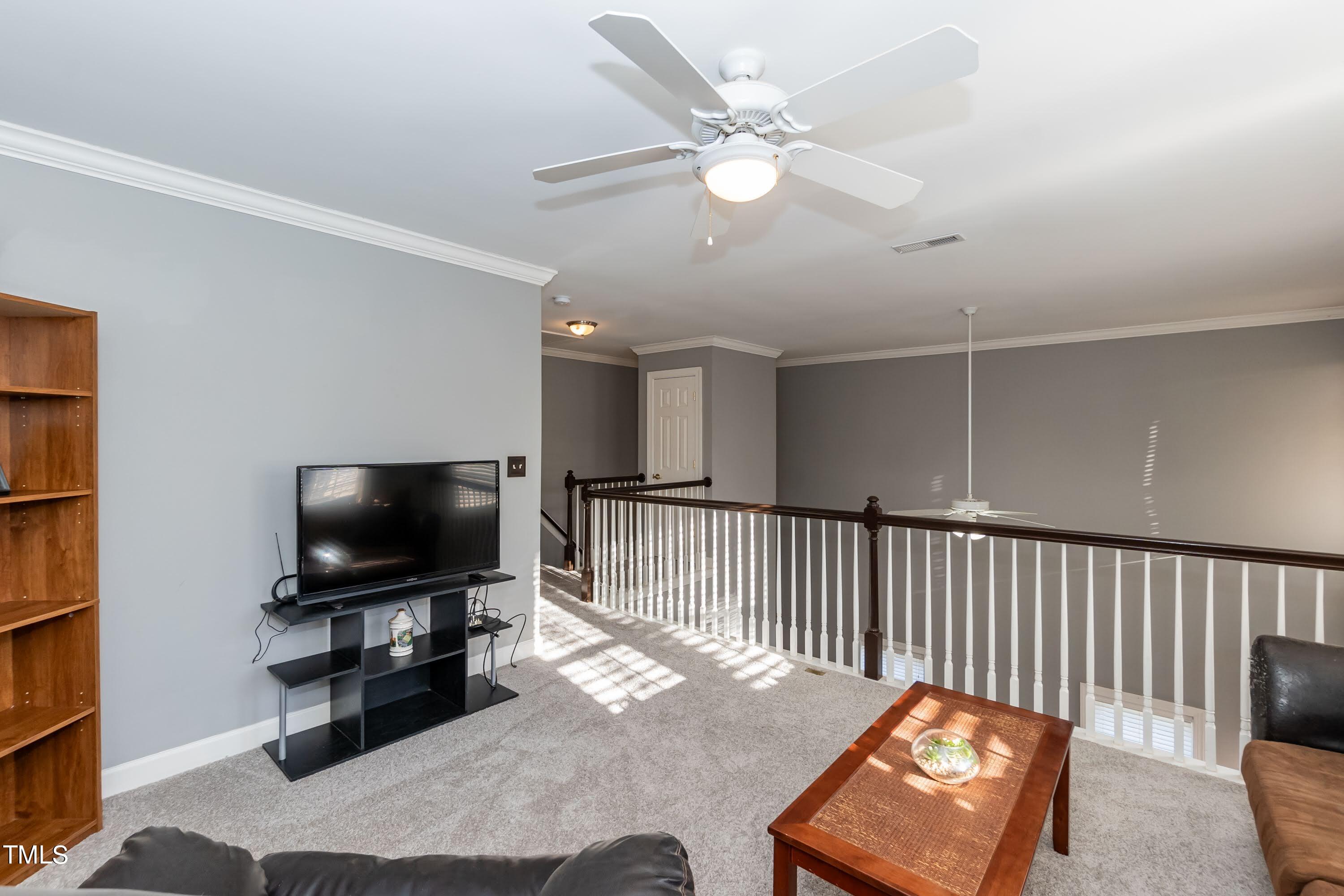 5001 Morning Edge Drive Raleigh, NC 27613 - Photo 21 of 25 a living room with furniture and a flat screen tv