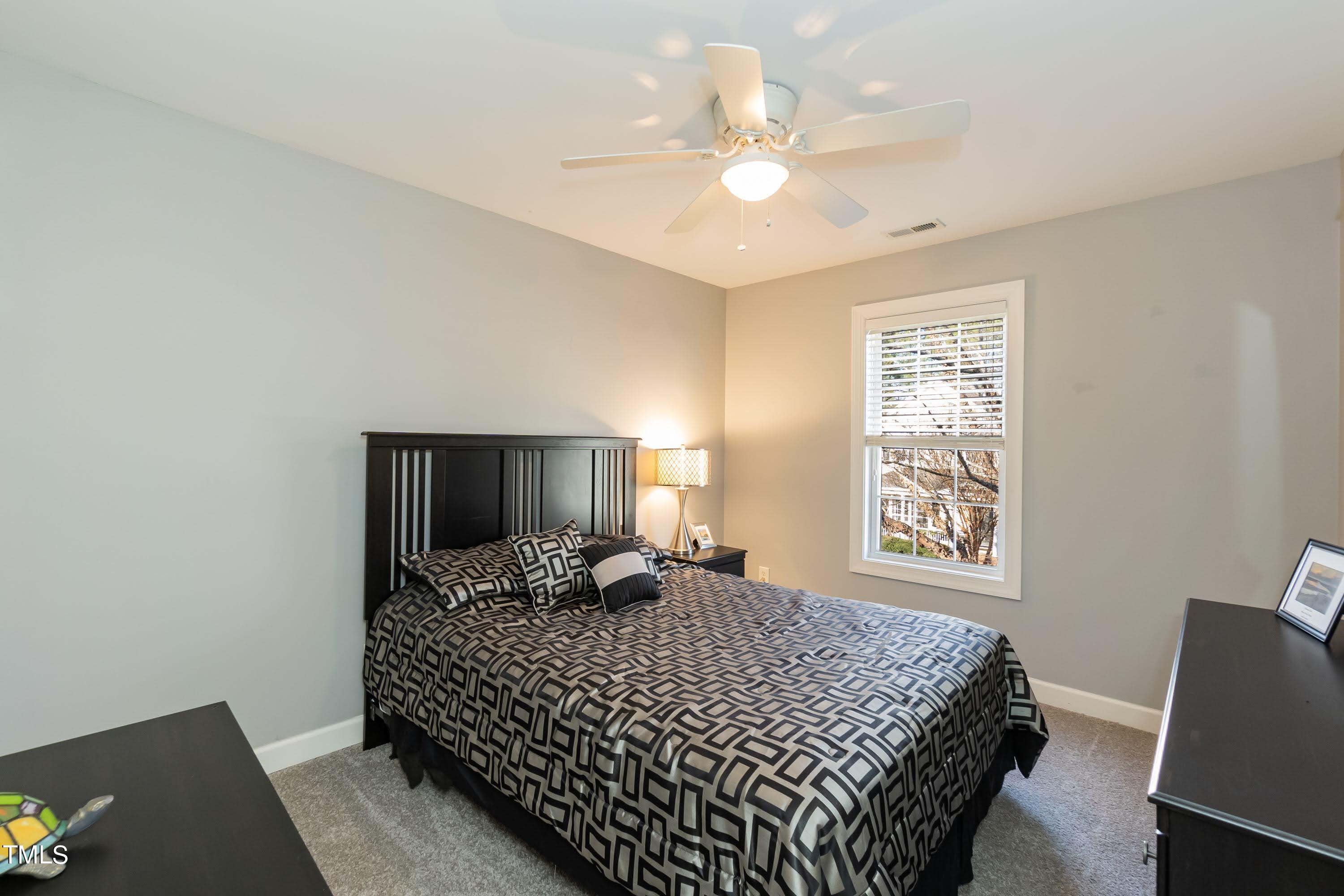 5001 Morning Edge Drive Raleigh, NC 27613 - Photo 22 of 25 a bedroom with a bed and a window