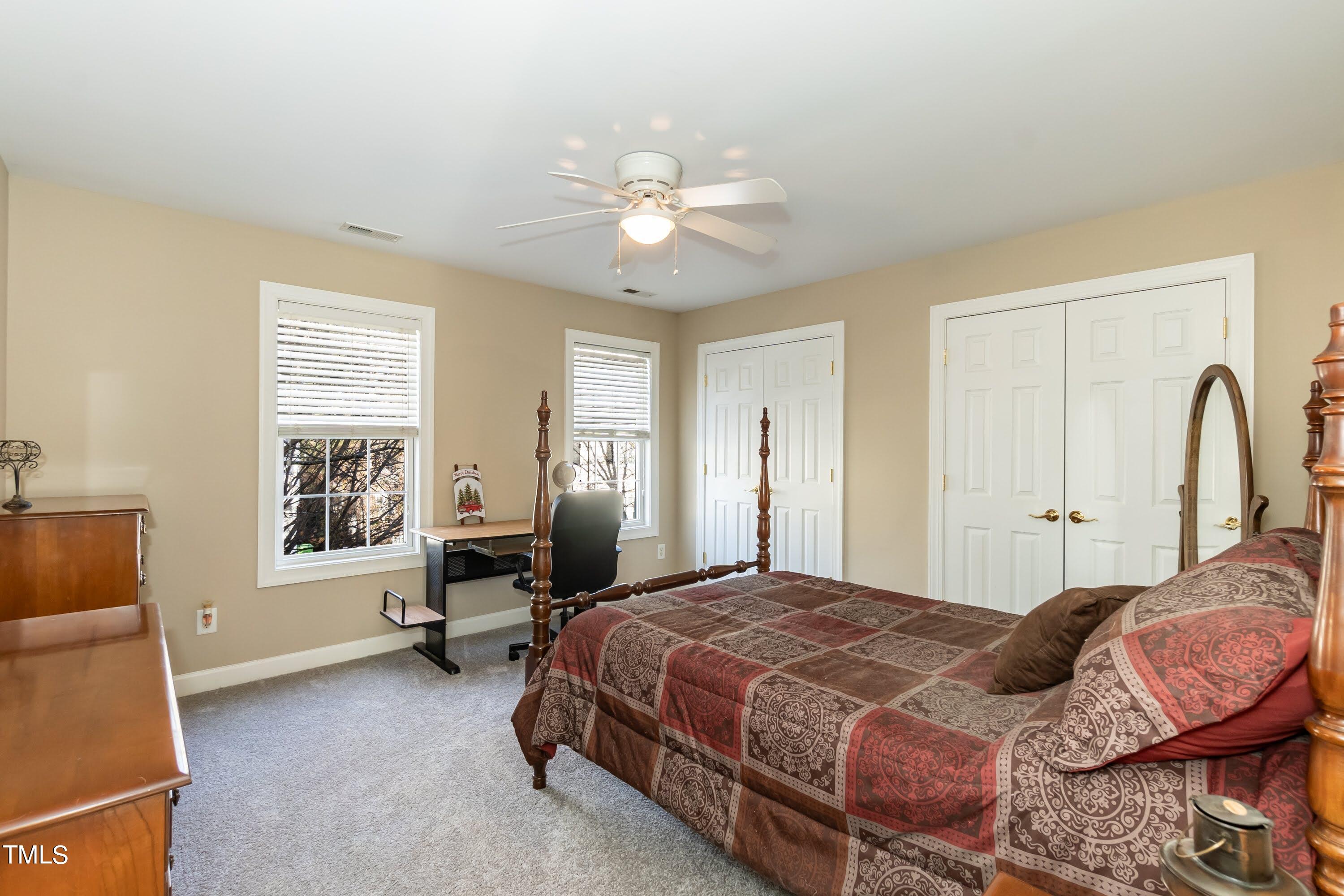 5001 Morning Edge Drive Raleigh, NC 27613 - Photo 23 of 25 a bedroom with a bed and window