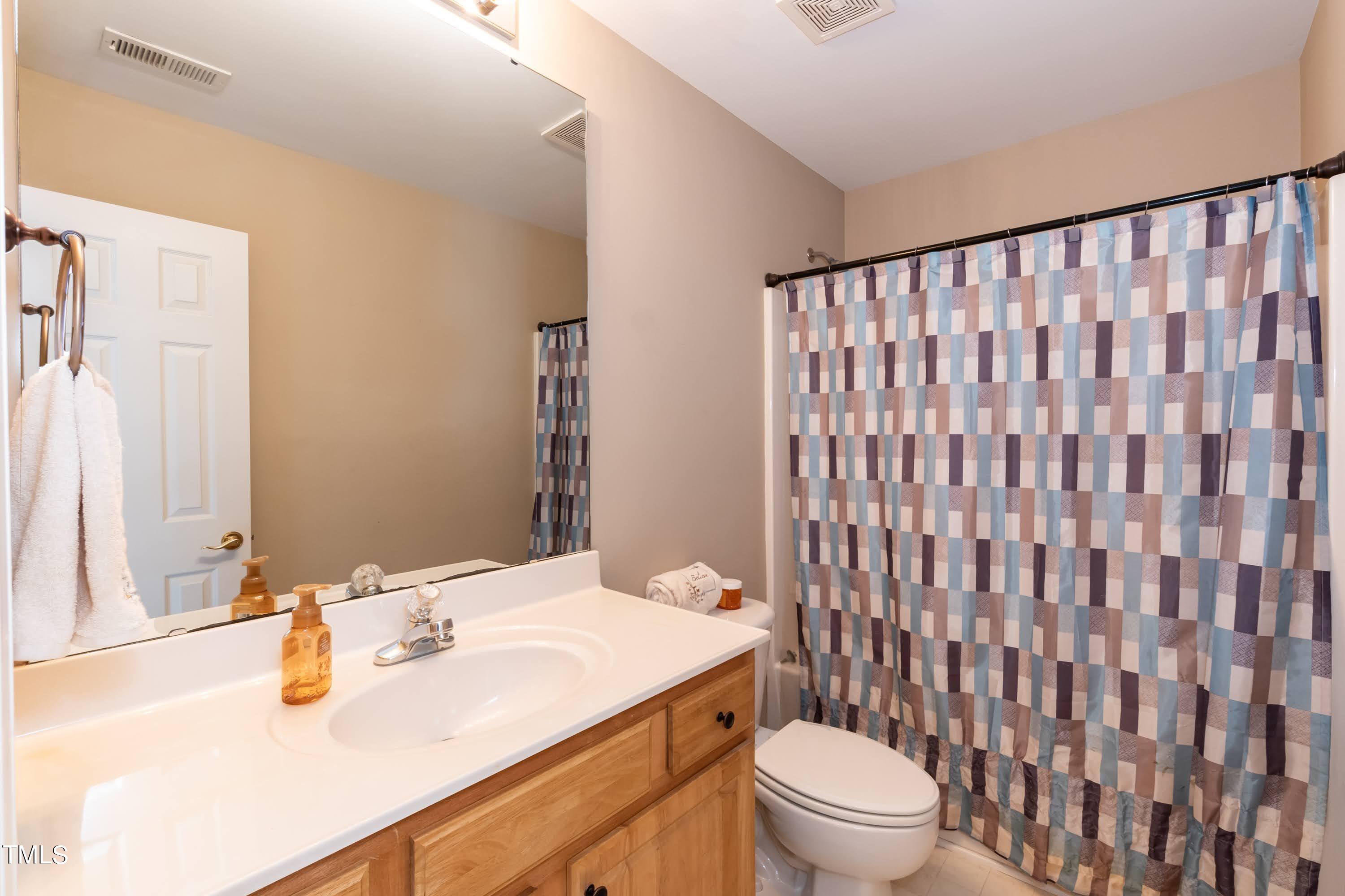 5001 Morning Edge Drive Raleigh, NC 27613 - Photo 24 of 25 a bathroom with a sink toilet and shower