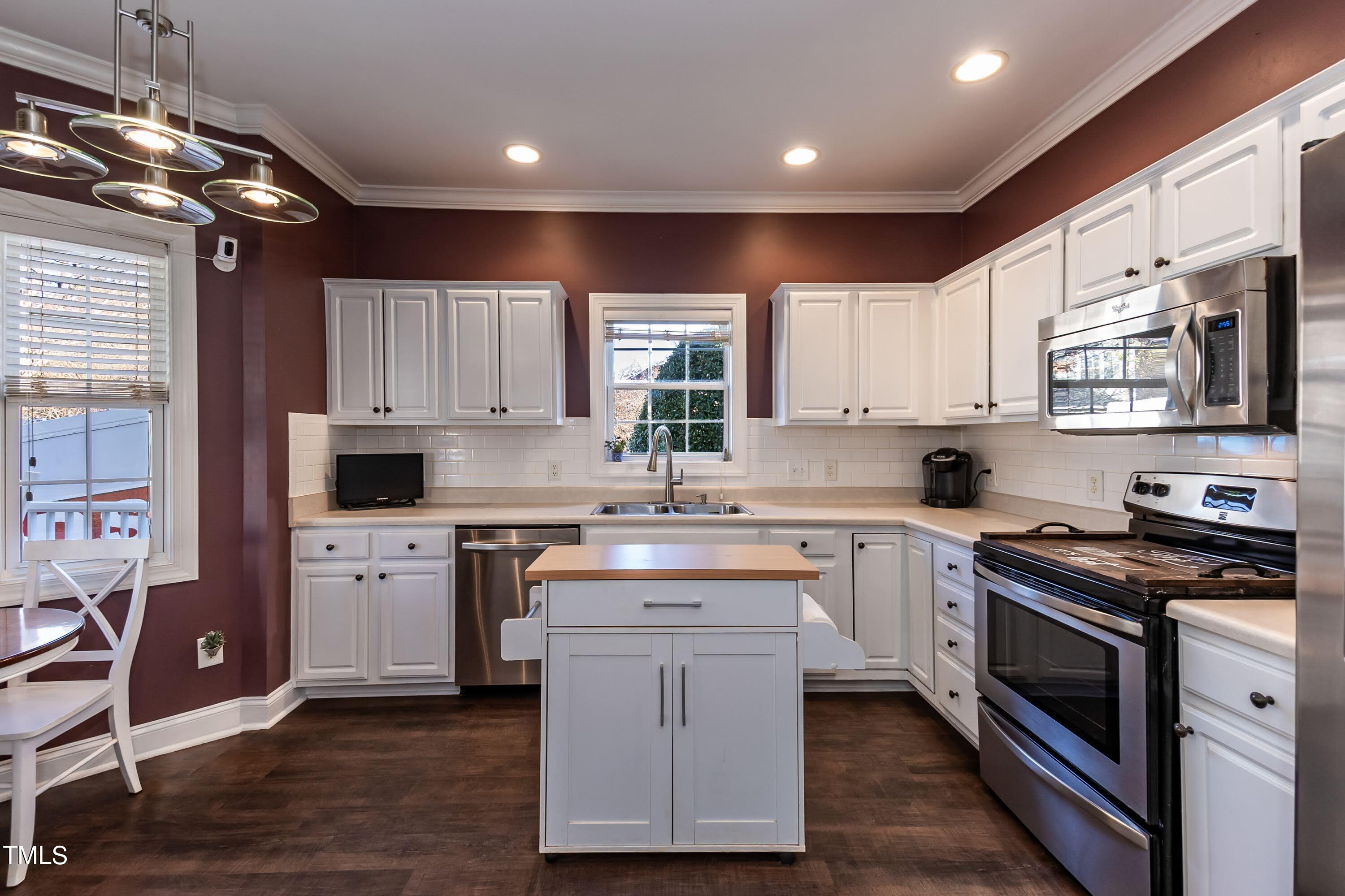 5001 Morning Edge Drive Raleigh, NC 27613 - Photo 8 of 25 a kitchen with a white cabinets and white appliances