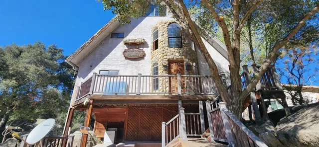 a view of a house with wooden fence