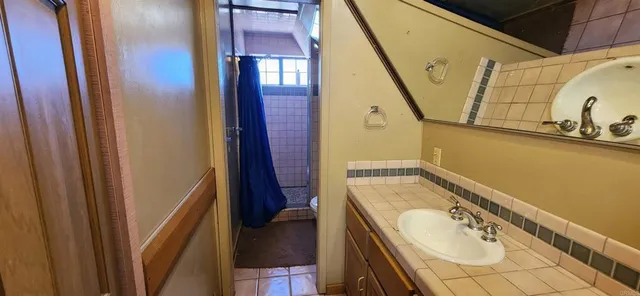 a bathroom with a sink a mirror and a bathtub