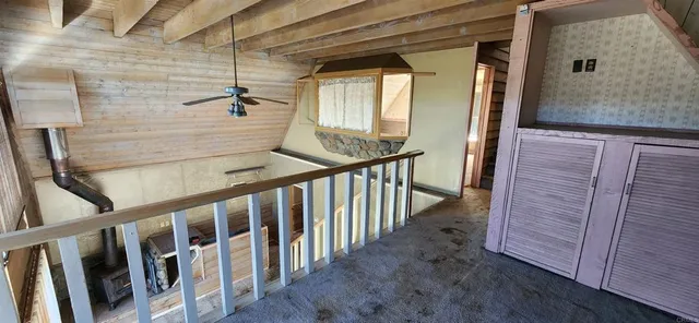 a view of staircase with railing and a window