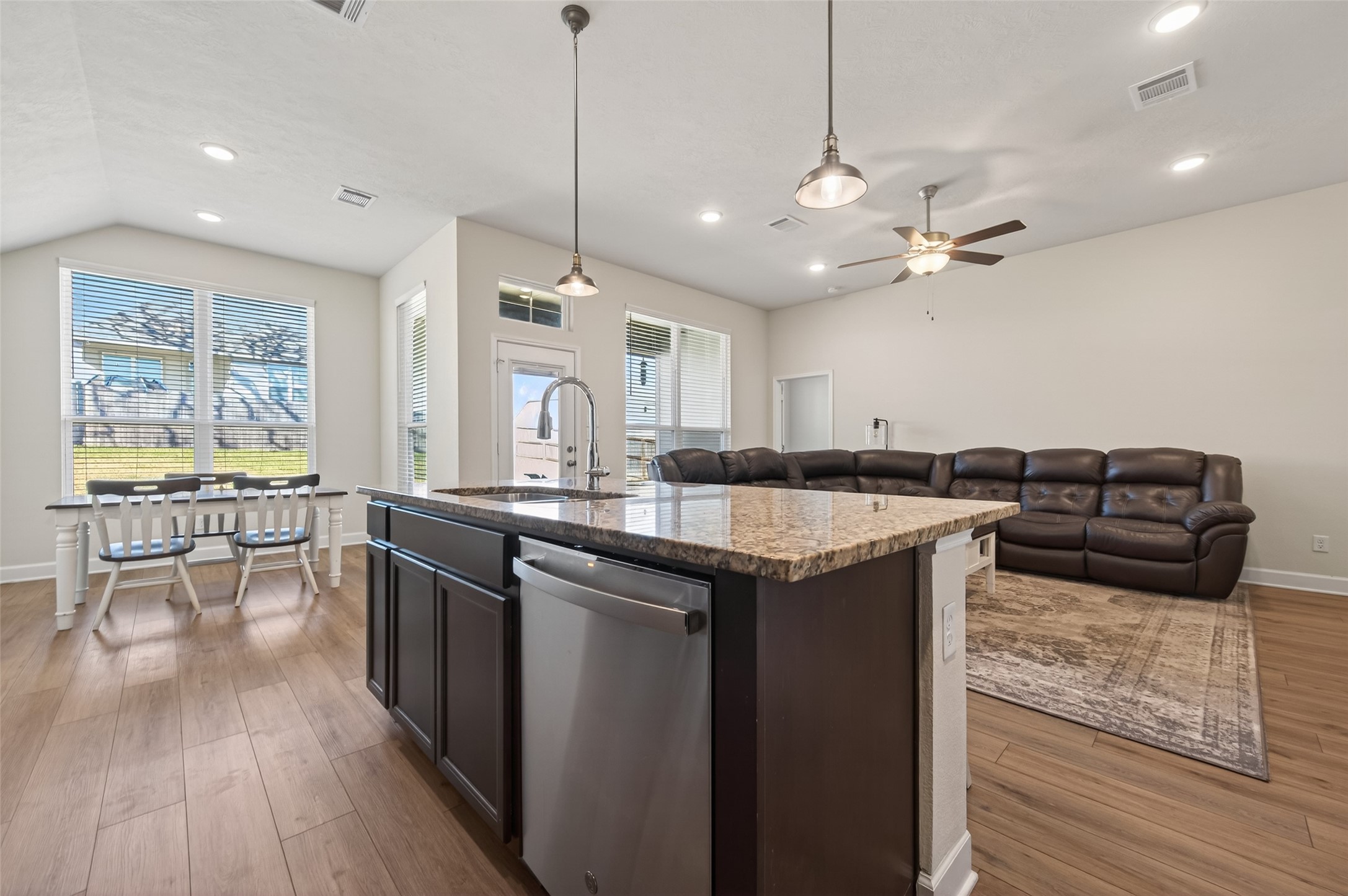 917 Farm Path Brenham, TX 77833 - Photo 15 of 43 a kitchen with kitchen island granite countertop a sink and a stove top oven